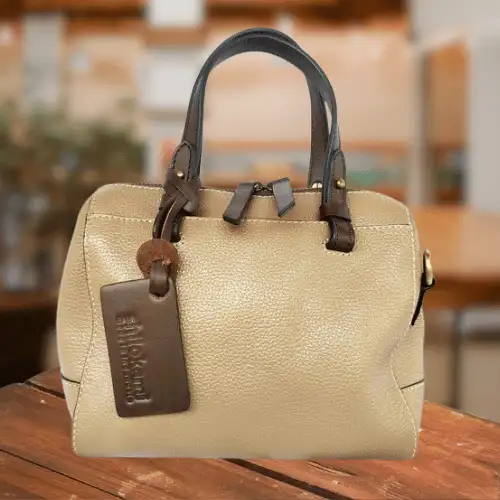 Classic, simple leather bag that pairs beautifully with Minangkabau songket.