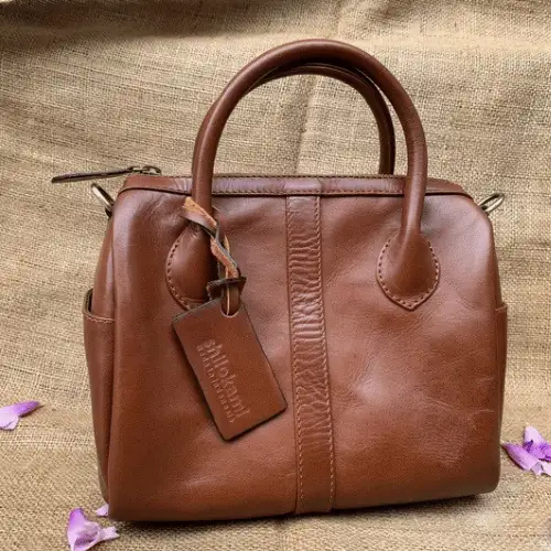 Compact tube bag with an adjustable strap and spacious compartment.